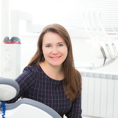 Female dental patient smiling after bone graft in Huntington Beach, CA