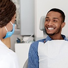 Man smiling at his implant dentist in Huntington Beach