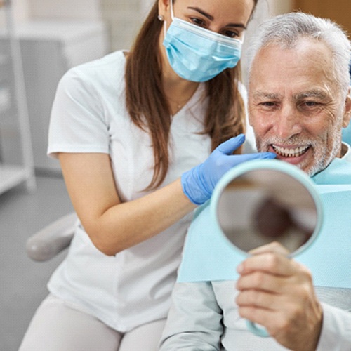 Patient viewing his dental implants in Huntington Beach