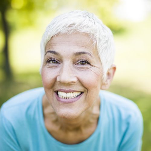 Smiling older woman outdoors