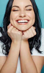 Woman smiling with her eyes closed