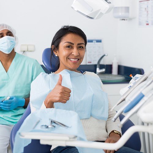 Female patient giving thumbs up after her appointment