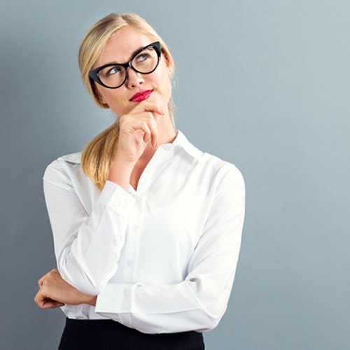 A woman thinking with her arms crossed.