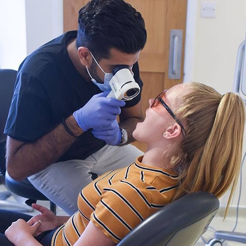 Team member performing oral cancer screening