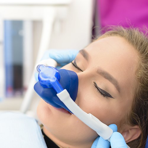 Woman with nitrous oxide nose mask