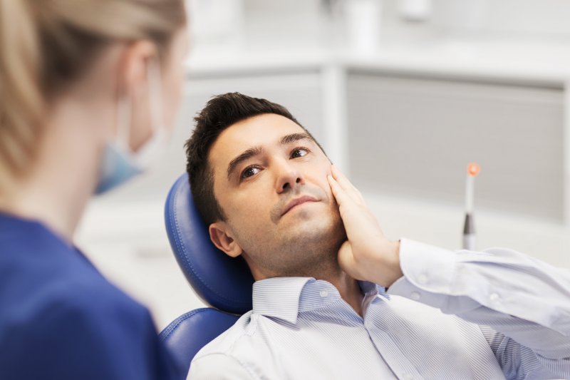 Man with failing dental implants in Huntington Beach visiting dentist