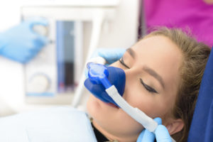 Woman with dental sedation nitrous oxide mask at dental office