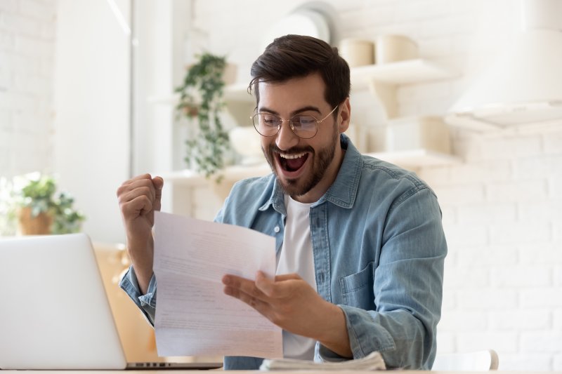 man smiling and excited for tax refund in Huntington Beach