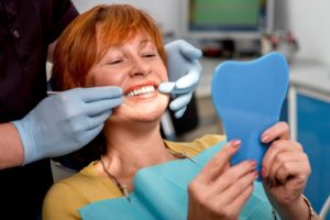 a woman smiling during her dental implant consultation