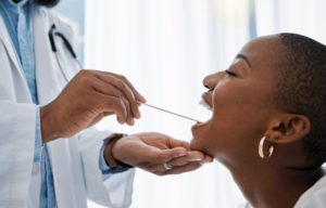 a person receiving an oral cancer screening