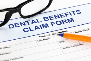 Dental insurance form with glasses and a mechanical pencil