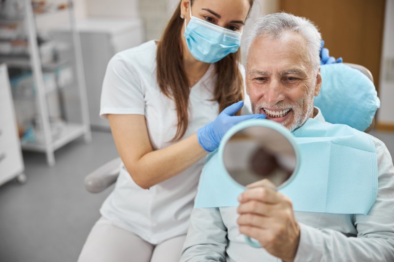 An aging gentleman happy with his new dental implants