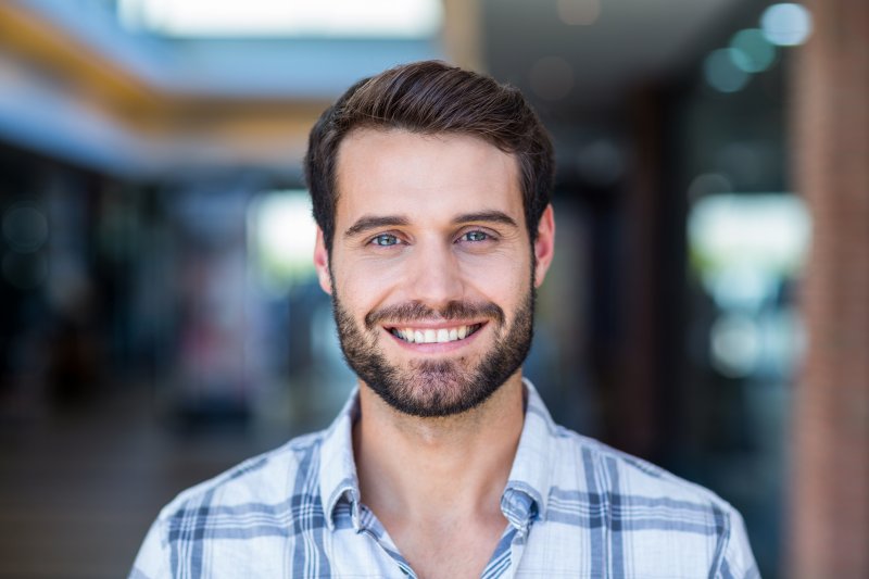 patient smiling after getting dental implant surgery