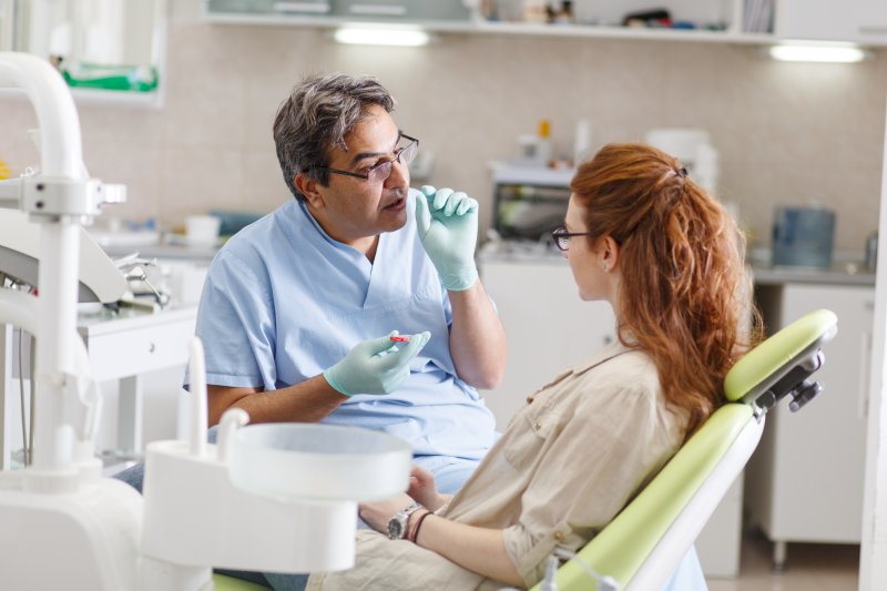 Dentist talking to patient about dental implants